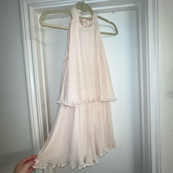 Adorable cream chiffon ruffle short romper with tie back. Open winged back. - Picture 10 of 13